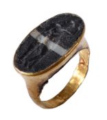 A Roman gold intaglio ring, circa 2nd-3rd century AD, the banded black and white paste engraved