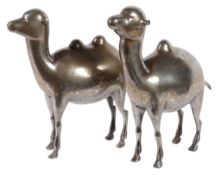 A pair of Qajar metalwork Camels, Persia, 19th century, with inlaid decoration, 27.5cm high x 26cm