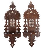 Ω A pair of Egyptian carved and stained hardwood wall brackets, with mashrabiya work panels and