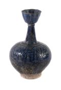 A Kashan blue-glazed bottle vase , Persia, 12th century or later, the frit body of baluster form