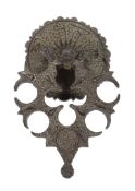 An inlaid bronze door knocker, Mamluk, Egypt or Syria, the convex disc with serrated rim, the