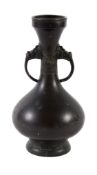 A Chinese bronze two-handled vase , Qing Dynasty, cast with archaic motifs and two mask handles,