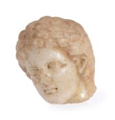 A Greek marble head of a youth, circa 4th-3rd century BC, the face framed by thickly curled hair,