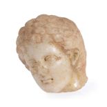 A Greek marble head of a youth, circa 4th-3rd century BC, the face framed by thickly curled hair,