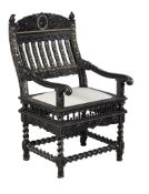 Ω An Indian carved ebony and ivory inlaid armchair, late 17th century, Coromandel Coast, the