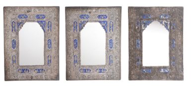 Three Indian silver coloured and enamel wall mirrors, unmarked, chased with beaded, floral and