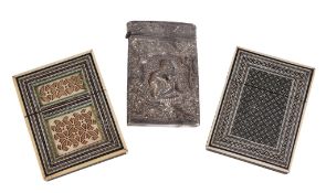 A Burmese silver rectangular card case, circa 1900, with seated figures in relief within shaped