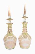 Two similar Bohemian/Czech or Beykoz clear and enamelled glass large bottles and spire stoppers for