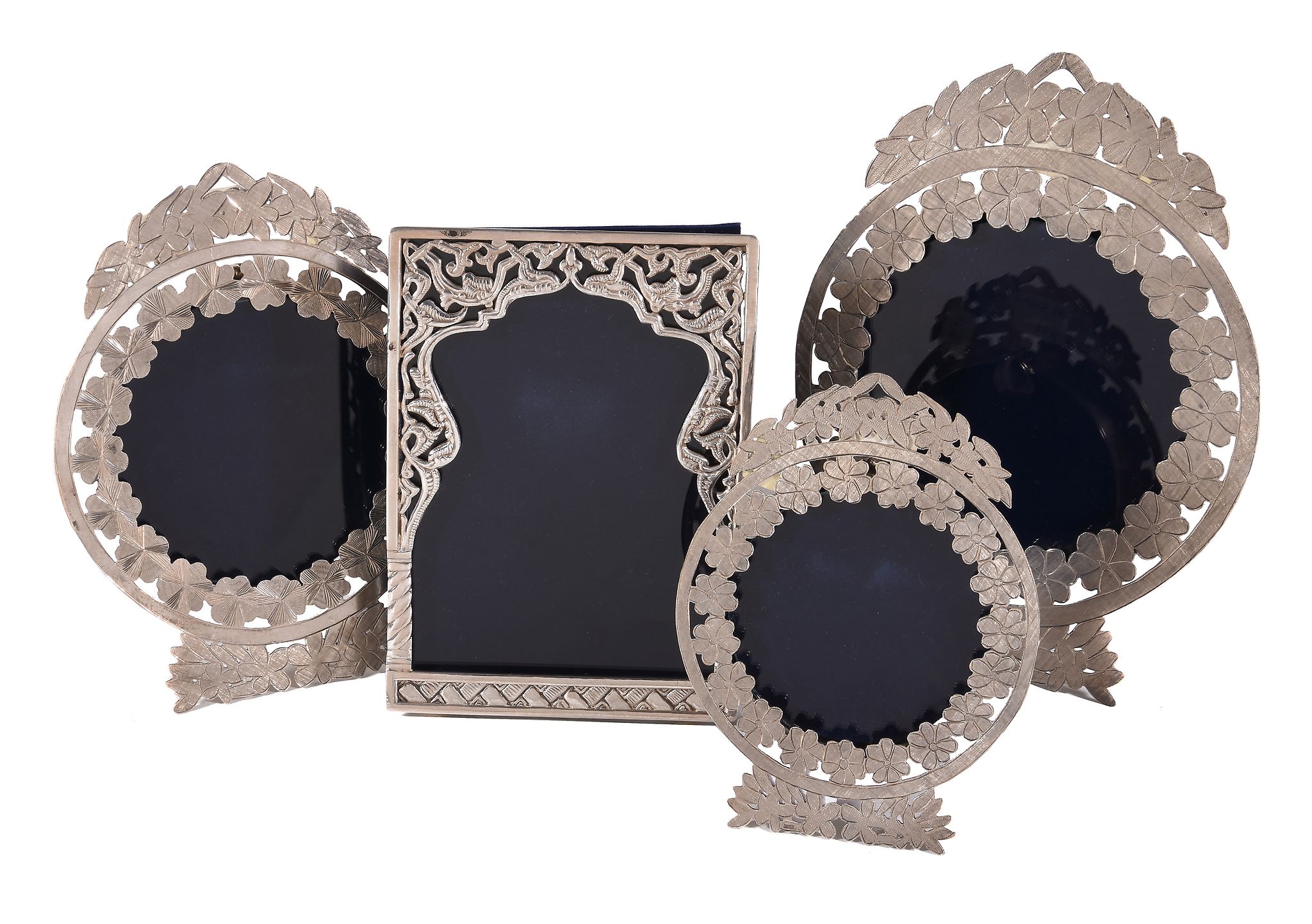 An Egyptian silver coloured rectangular photograph frame, chased and pierced with scroll work, 16.