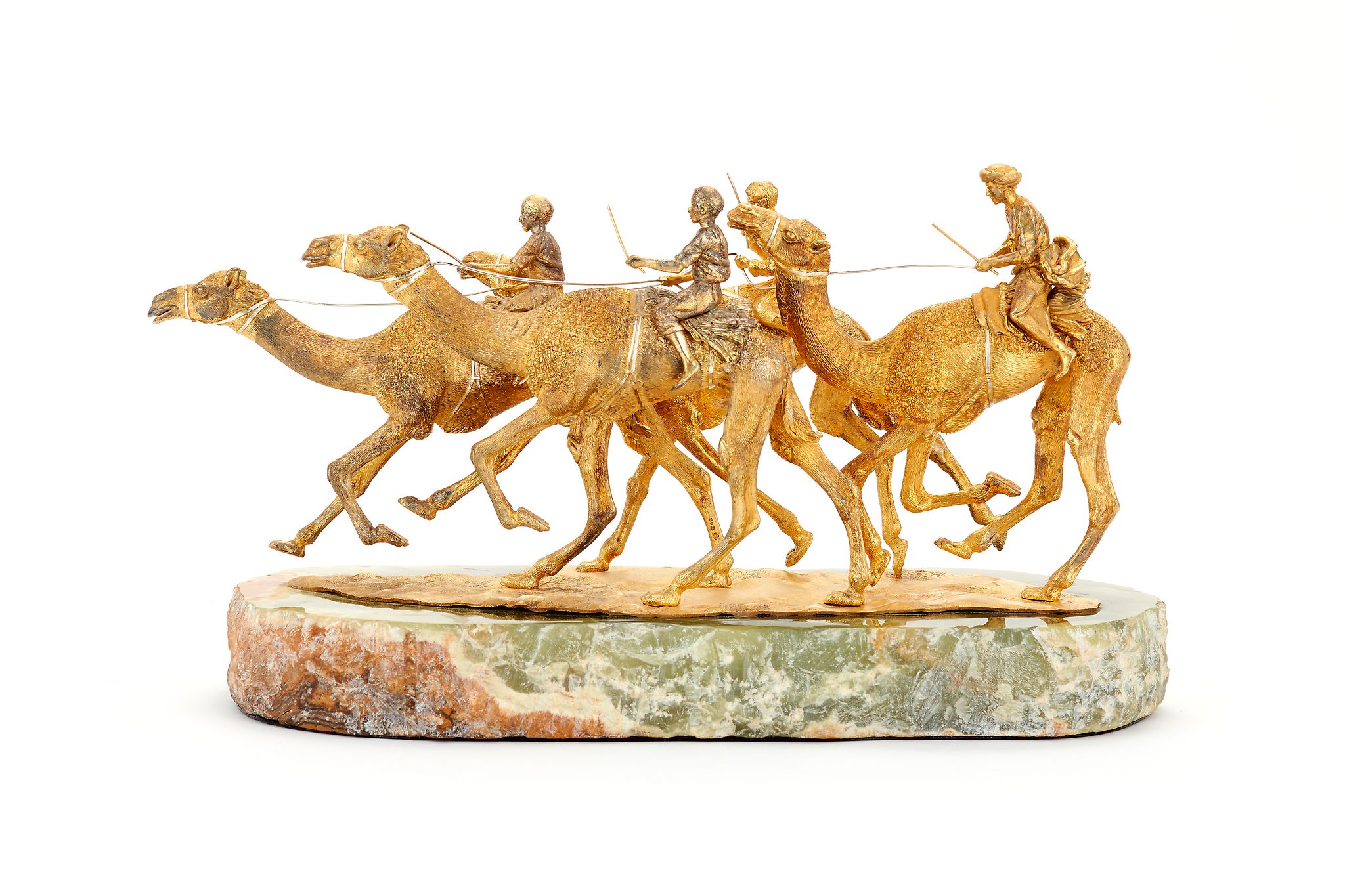 Asprey, a silver gilt model of four racing camels with jockeys up by Asprey & Co., London 1982, the