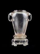 A Chinese rock crystal vase, the slender body of oval section with two handles, on canted base with