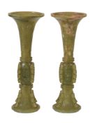 A pair of Chinese celadon and russet jade archaistic vases, gu , 19th or early 20th century, of