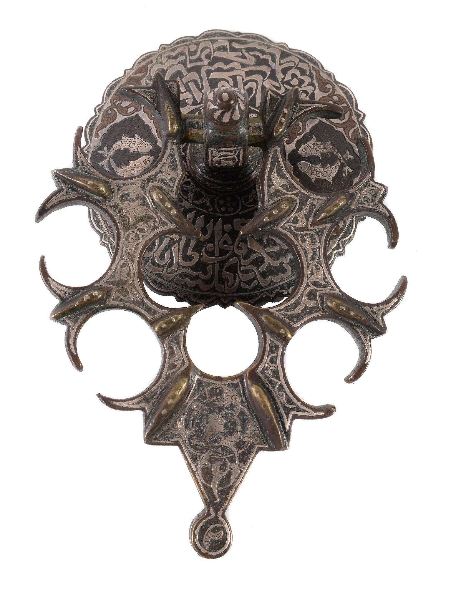 A silver-inlaid bronze door knocker, Mamluk, Egypt or Syria, the convex disc with scalloped rim,