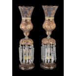 A pair of Czech or Beykoz clear glass and gilt table lustres with storm shades, for the Near