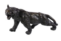 A Japanese bronze model of a Tiger, Meiji Period, modelled realistically prowling and roaring,