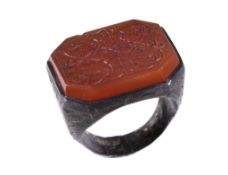 A Near Eastern cornelian intaglio signet ring, probably Persian, the cornelian plague engraved in