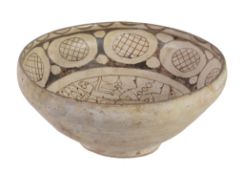 A Persian slip-decorated bowl, probably Nishapur, 10th-11th century or later, decorated in