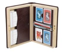 Asprey, a bridge set in the form of a leather book, containing four sets of cards, eight pencils