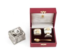 Asprey, an enamel and silver gilt christening set, comprising: a napkin ring, an egg cup and silver