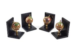 Asprey, a set of four black leather bookends, each with a miniature globe, 16cm high, in an Asprey