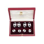 A pair of silver and enamel cufflinks and four dress studs, retailed by Asprey, the double sided