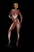 δ John Huggins, FRBS (British b. 1938), part polished bronze figure of a stylised nude standing,