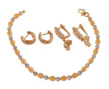 A gold coloured bracelet, composed of fancy links, stamped 916, 19cm long; a pair of white stones