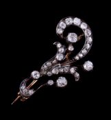 A Victorian diamond spray brooch, circa 1870, the scrolled foliate brooch set with old cut