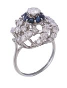 A 1970s diamond and sapphire cluster ring, the central brilliant cut diamond, estimated to weigh 0.