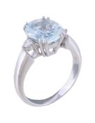 An aquamarine and diamond ring, the oval cut aquamarine claw set between brilliant cut diamond set