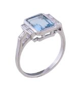 An aquamarine and diamond ring, the rectangular cut aquamarine between baguette cut diamonds,