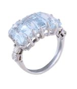 An aquamarine and diamond ring, the three rectangular cut aquamarines claw set between brilliant