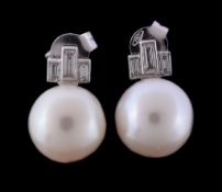 A pair of cultured pearl and diamond earrings, the cultured pearls each set below a baguette cut