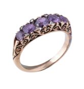 An early 20th century purple sapphire and diamond ring, the circular cut purple sapphires with rose
