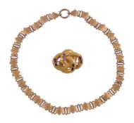 A Victorian gold necklace, circa 1880, the hexagonal shaped panels with engraved flower detail,