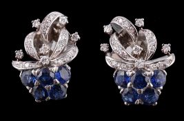 A pair of sapphire and diamond foliate spray earrings, circa 1960, the pediments with a half