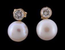 A pair of cultured pearl and diamond earrings, the cultured pearls each set below a brilliant cut