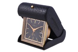 Gubelin, a gilt metal and leather travelling alarm clock, Swiss 8 day alarm movement, 15 jewels,