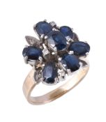 A sapphire and diamond cluster ring, set with oval cut sapphires and eight cut diamonds, finger