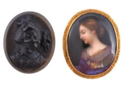 A Victorian enamel portrait brooch, circa 1880, the oval brooch painted with the profile of a