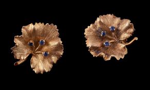 A pair of 18 carat gold sapphire earrings, designed as leaves, each set with three sapphires, with