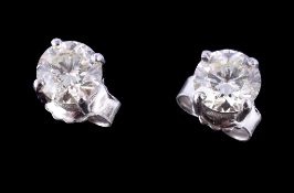 A pair of single stone diamond ear studs, the brilliant cut diamonds estimated to weigh 0.90 carats