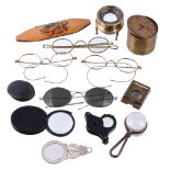A Mauchline ware spectacles case, various spectacles, magnifying glasses and loupes, the slip-in