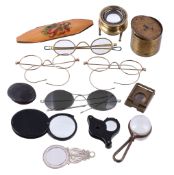 A Mauchline ware spectacles case, various spectacles, magnifying glasses and loupes, the slip-in