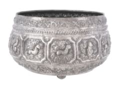 A Burmese silver rice bowl, script mark beneath, circa 1900, chased with shaped square panels of