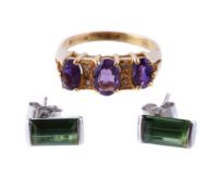 An 18 carat gold amethyst and diamond ring, set with three oval cut amethysts with eight cut