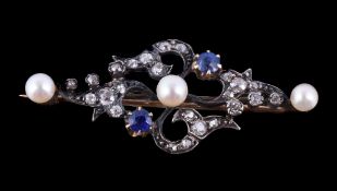 A Victorian sapphire, diamond and pearl brooch , circa 1890, the scrolled foliate brooch set with