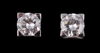 A pair of brilliant cut diamond ear studs, the brilliant cut diamonds, stated to weigh 0.58 and 0.