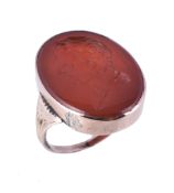 A William IV cornelian intaglio signet ring, circa 1835, the oval cornelian panel carved with an