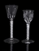 An engraved opaque-twist wine glass, circa 1760, the ogee bowl with everted rim decorated with a